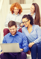 Image showing team with laptop and tablet pc on staircase