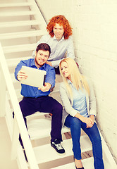 Image showing team with tablet pc computer sitting on staircase