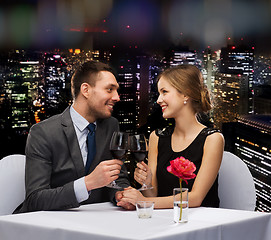 Image showing young couple with glasses of wine at restaurant
