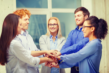 Image showing team with hands on top of each other in office