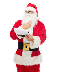 Image showing man in costume of santa claus with notepad