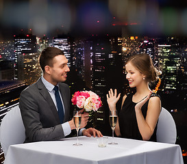 Image showing smiling man giving flower bouquet to woman
