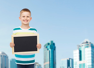 Image showing smiling little boy holding blank black chalkboard