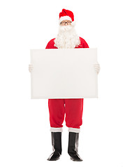 Image showing man in costume of santa claus with billboard