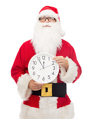 Image showing man in costume of santa claus with clock