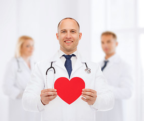 Image showing smiling male doctor with red heart and stethoscope