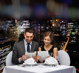 Image showing couple with menus on tablet pc at restaurant
