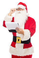 Image showing man in costume of santa claus with notepad