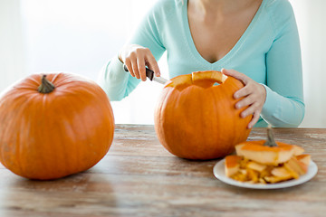 Image showing close up of woman with pumpkins at home