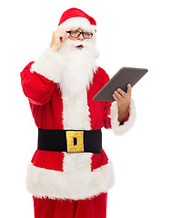 Image showing man in costume of santa claus with tablet pc