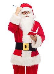 Image showing man in costume of santa claus with notepad