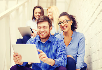 Image showing team with tablet pc computer sitting on staircase