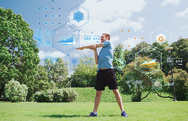 Image showing smiling man stretching outdoors