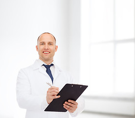 Image showing smiling male doctor with clipboard