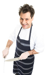 Image showing Smiling butcher or chef sharpens knife