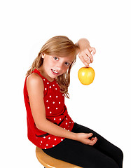 Image showing Girl playing with an apple.