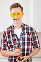 Image showing repairman with a dril