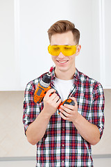 Image showing repairman with a dril