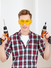 Image showing  repairman with a drill and a screwdriver