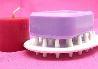 Image showing Lilac soap with candlet on a  pink background