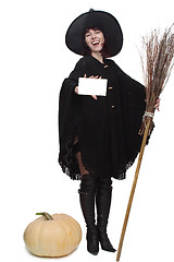 Image showing Witch holding a card