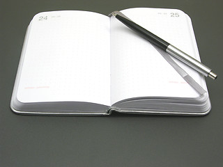 Image showing To flip an appointment calendar open with ball pen