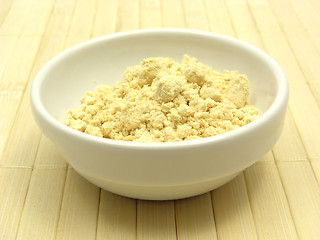 Image showing Soy meal in a little white bowl of chinaware on a placemat