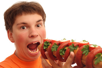 Image showing Boy eating big crazy sandwich