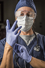 Image showing Concerned Female Doctor or Nurse Putting on Protective Facial We