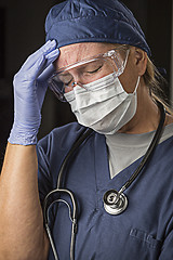Image showing Grimacing Female Doctor or Nurse Wearing Protective Wear