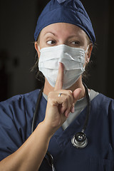 Image showing Secretive Female Doctor with Finger in Front of Mouth