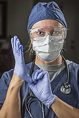 Image showing Concerned Female Doctor or Nurse Putting on Protective Facial We