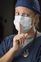 Image showing Secretive Female Doctor with Finger in Front of Mouth