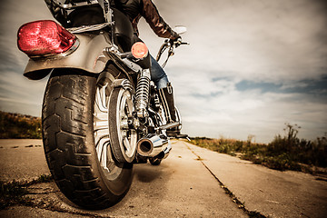 Image showing Biker girl riding on a motorcycle