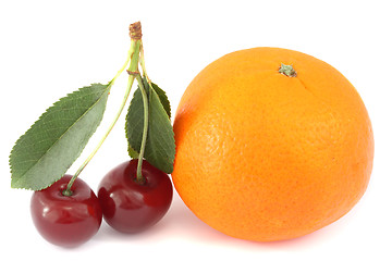 Image showing Mandarine and two sour cherries