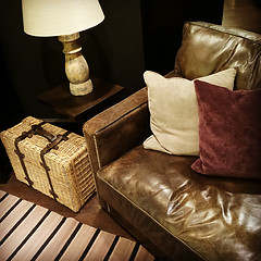 Image showing Leather sofa, lamp and rattan suitcase