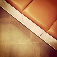 Image showing Leather bench on wooden floor