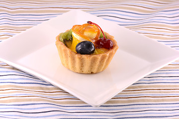 Image showing Chocolate cake with cherry and olive on white plate