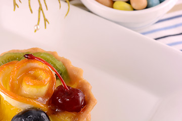 Image showing Chocolate cake with cherry and olive on white plate