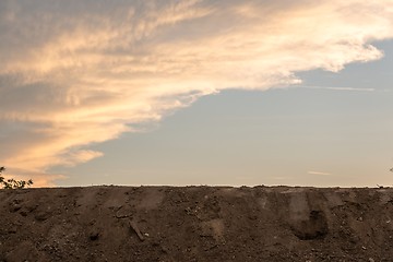 Image showing Large pile of soil under blue sky