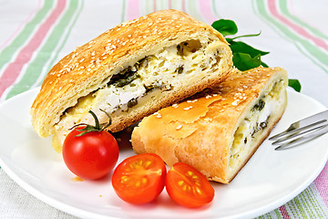 Image showing Roll filled with spinach and cheese in bowl on tablecloth