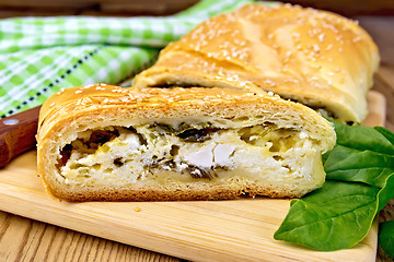 Image showing Roll filled with spinach and cheese on board