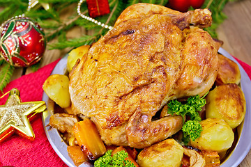 Image showing Chicken with red Christmas toys on board