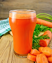 Image showing Juice carrot with napkin on board