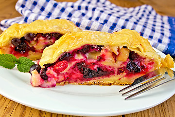 Image showing Strudel with black currants and napkin on board