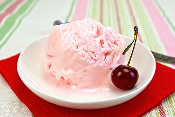 Image showing Ice cream cherry on red paper napkin