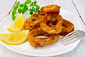 Image showing Calamari fried with lemon on plate