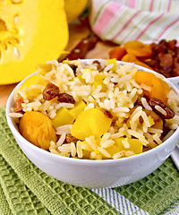 Image showing Pilaf fruit with pumpkin in bowl on board