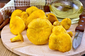 Image showing Chanterelles with a knife on the board