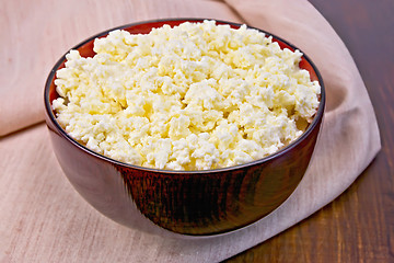 Image showing Curd in wooden bowl on board with cloth